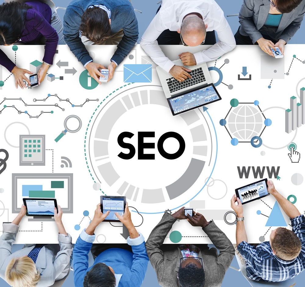 Group of people using digital devices around a table with the word “SEO” and various icons related to web analytics, search, and internet.